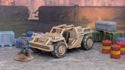 Image of a 28mm scale 4-wheel dune buggy surrounded by various barrels and boxes.
